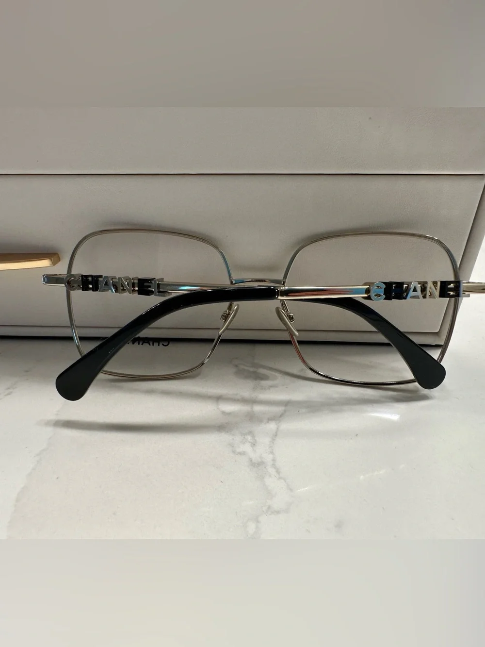 CHANEL Gold Frame Glasses with Black Temple Tips